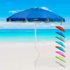 A blue beach umbrella is set up on a sandy beach with the ocean and sky in the background. Several other colored umbrellas are displayed to the right. Anteprima dell’immagine prodotto