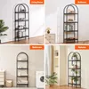 Collage of four images showing a black metal bookshelf in different room settings: living room, bedroom, bathroom, and balcony. Náhled obrázku produktu