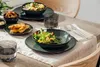 A table setting with plates of food and drinks. Produktbild-Vorschau