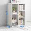 A white, open bookshelf with several shelves, displaying books, a plant, and a teddy bear. Náhled obrázku produktu