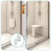 A split image showing a wall-mounted shower seat in both folded and unfolded positions within a modern shower stall. Produktbild-Vorschau