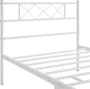 A close-up view of a white metal bed frame, showing the headboard and part of the mattress support. Produktbild-Vorschau