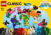 The image shows the packaging of a LEGO Classic set, featuring a world map with various LEGO builds of animals, vehicles, and buildings placed on different continents. The bottom of the image displays a large pile of colorful LEGO bricks. Produktbild-Vorschau