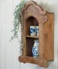 A wooden wall shelf with decorative items and a hanging plant. Náhled obrázku produktu