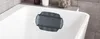 A close-up view of a gray bath pillow resting on the edge of a white bathtub. Produktbild-Vorschau