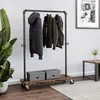 A clothing rack with coats on it, two storage boxes on the bottom shelf, and a plant in a pot to the left. Náhled obrázku produktu