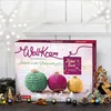 A ROTH "WollKram" Advent calendar for 2023, featuring crocheted Christmas ornaments on the front, set against a festive, slightly blurred background with decorative stars and greenery. Produktbild-Vorschau