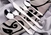 A set of silverware laid out on a patterned cloth. Produktbild-Vorschau