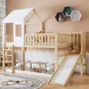 A child's bedroom with a wooden loft bed featuring a house-shaped top, slide, and ladder. Decorated with toys and children's items. Podgląd zdjęcia produktu
