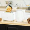 A white toaster and a white electric kettle are displayed on a wooden countertop in a kitchen setting. Produktbild-Vorschau