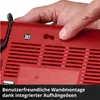 A hand is holding a red charger, showing its wall mounting feature. Voir les images du produit