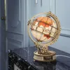 A wooden globe model with internal lighting sits on a marble table. Náhľad obrázku produktu