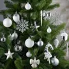 A close-up view of a decorated Christmas tree with various ornaments. Produktbild-Vorschau