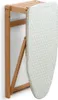 A wall-mounted ironing board is shown folded and hanging against a white wall. Voir les images du produit