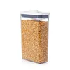 A clear, professional studio shot of a food storage container filled with popcorn kernels, isolated on a white background. Produktbild-Vorschau