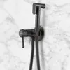 A black bidet faucet mounted on a marble wall. Podgląd zdjęcia produktu