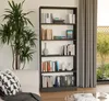 A modern living room with a bookshelf filled with books and decorative items, next to a sofa and a large plant. Voir les images du produit