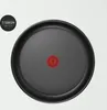 A close-up, top-down view of the bottom of a frying pan. Podgląd zdjęcia produktu