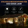 A house decorated with string lights at night. Produktbild-Vorschau