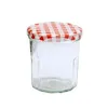 A clear studio shot of a glass jar with a red and white checkered lid. Produktbild-Vorschau