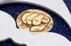 A close-up view of a watch face with a gold-colored fist design against a dark blue, starry background. Produktbild-Vorschau