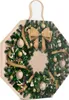 An advent calendar shaped like a Christmas wreath, decorated with ornaments and a bow. Produktbild-Vorschau