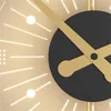 A close-up view of a modern wall clock with gold hands and a black center. Produktbild-Vorschau