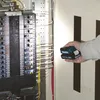 A hand holding a Makita battery near an electrical panel. Produktbild-Vorschau