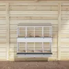 A white metal chicken nesting box with 8 compartments is mounted on a wooden wall. Voir les images du produit