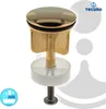 A close-up studio shot of a gold-plated drain stopper. Produktbild-Vorschau
