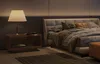 A bedroom scene with a bed, nightstand, and lamp. Náhled obrázku produktu