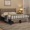 A bedroom scene with a metal bed frame, bedding, and a bedside table with a lamp. Podgląd zdjęcia produktu