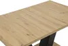A close-up view of a wooden table with black legs. Produktbild-Vorschau