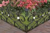 A decorative metal garden border with integrated solar lights, framing a flower bed with pink azaleas and green foliage. Produktbild-Vorschau
