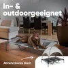 A brown dog is lying on a raised dog bed with a canopy in a living room setting. Produktbild-Vorschau