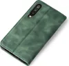 A green flip cover phone case is shown from a diagonal angle on a white background. Produktbild-Vorschau