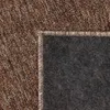 A close-up view of a rug, showing the texture and edge. Náhled obrázku produktu
