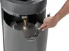 A hand is shown opening a panel on a gas patio heater to reveal the propane tank inside. Produktbild-Vorschau
