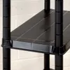 A close-up view of a black plastic shelf on a shelving unit. Produktbild-Vorschau