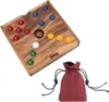 A wooden board game with colorful marbles and a die, next to a drawstring pouch. Produktbild-Vorschau
