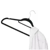 A black velvet hanger with a white shirt collar draped over it, on a white background. Produktbild-Vorschau