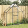 A greenhouse with gardening tools and plants in a backyard setting. Produktbild-Vorschau