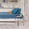 A child's bedroom with a bed, shelves, and a side table. Produktbild-Vorschau