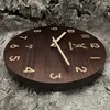 A wooden wall clock with a deer logo and brand name is displayed on a textured background. Voir les images du produit