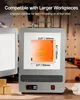 A close-up view of a metal furnace with its door open, displaying internal heating elements and dimensions. Podgląd zdjęcia produktu