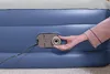 A close-up of a hand interacting with the inflation valve on an inflatable mattress. Produktbild-Vorschau