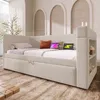 A beige upholstered daybed with integrated storage and charging ports, set in a modern, softly lit room with arched wall decor. Anteprima dell’immagine prodotto