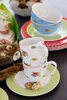 A stack of floral patterned cups and bowls with some Easter-themed decorations. Produktbild-Vorschau
