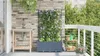 A balcony with a sink, a planter with climbing plants, and a small shelf with gardening tools. Náhľad obrázku produktu