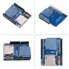 Four views of a blue electronic circuit board with an SD card slot and a coin cell battery holder. Náhled obrázku produktu